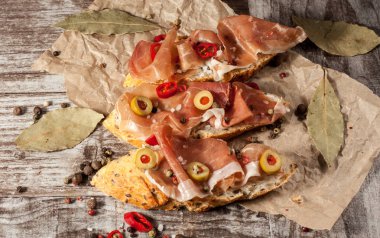 Bruschetta közlenmiş biber, prosciutto, sarımsak, zeytin, baharat ve otlar ile. Meze.