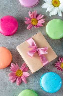 Pasta macarons, hediye kutusu, çay, kahve, cappuccino ve çiçek fotoğrafı. Tatlı romantik gıda acıbadem kurabiyesi kavramı. Sabah kahvaltı ve hediyeler. Sevgililer günü kavramı.