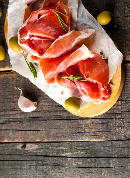 Closeup Thin Slices Prosciutto Mixed Olives Paprika Wooden Cutting Board — Stock Photo, Image