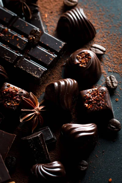 Stock image Assortment of dark, white and milk chocolate stack, chips. Chocolate and coffee beans on rustic wooden sacking background. Spices, cinnamon. Selective macro focus. Chocolates background. Sweets