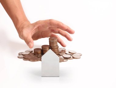 Bir el ve Model ev iş büyüyen para sikke yığını