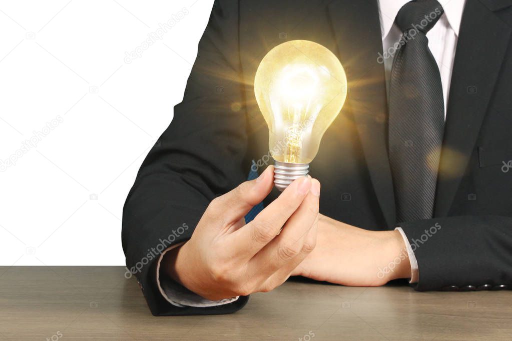 hand holding a light bulb with energy