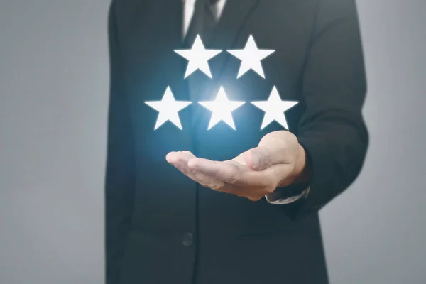 Hand touching five star symbol to increase rating