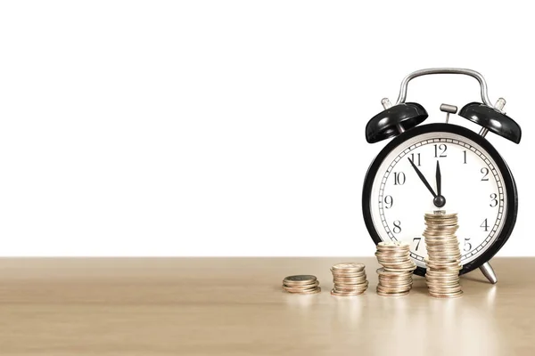 Time is money, table clock with coins Royalty Free Stock Photos