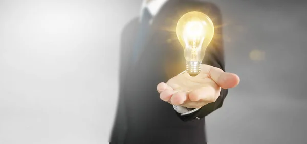 Hand of holding illuminated light bulb — Stock Photo, Image