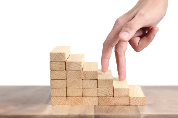 Hand liken person stepping up  toy staircase wood