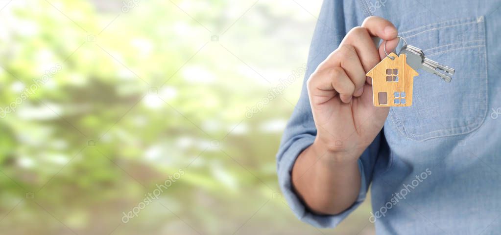 Real estate agent handing over house keys in hand