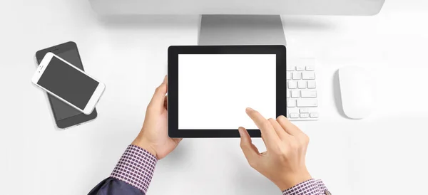 Hands holding a tablet touch computer gadget with isolated screen