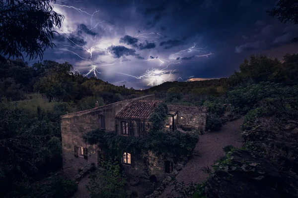 Dramatic electrical storm over an old olive mill and the distant Mediterranean sea in the Balagne region of Corsica