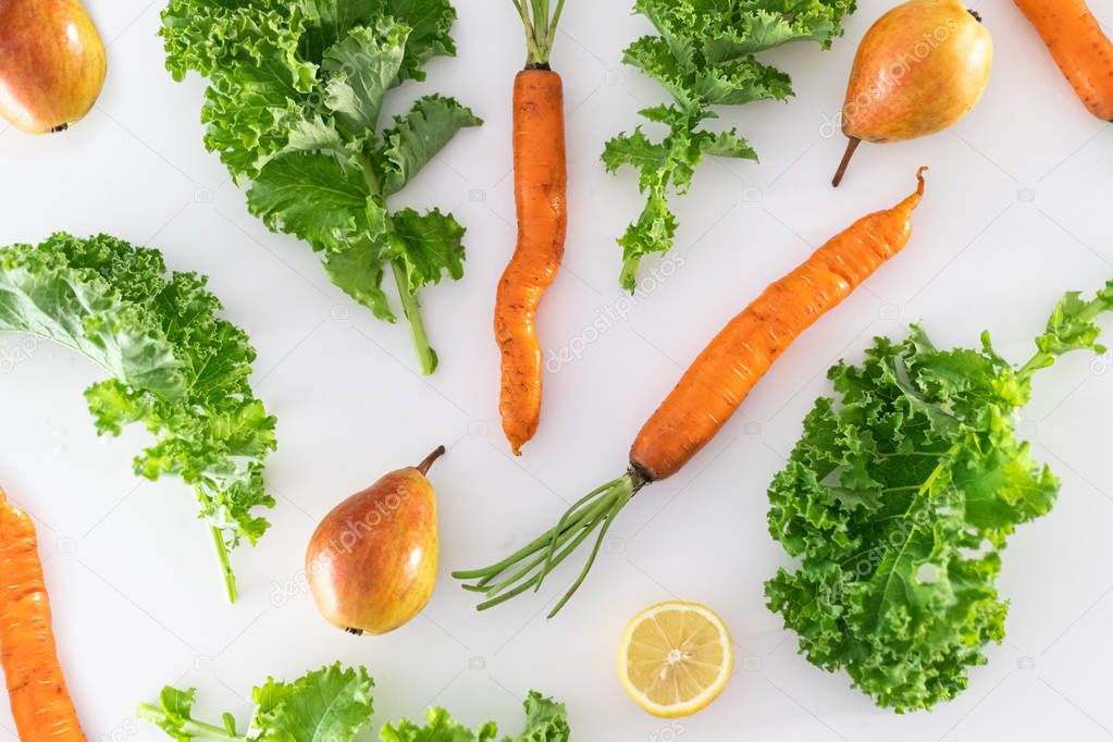 Dirty carrots, kale and pears on white background