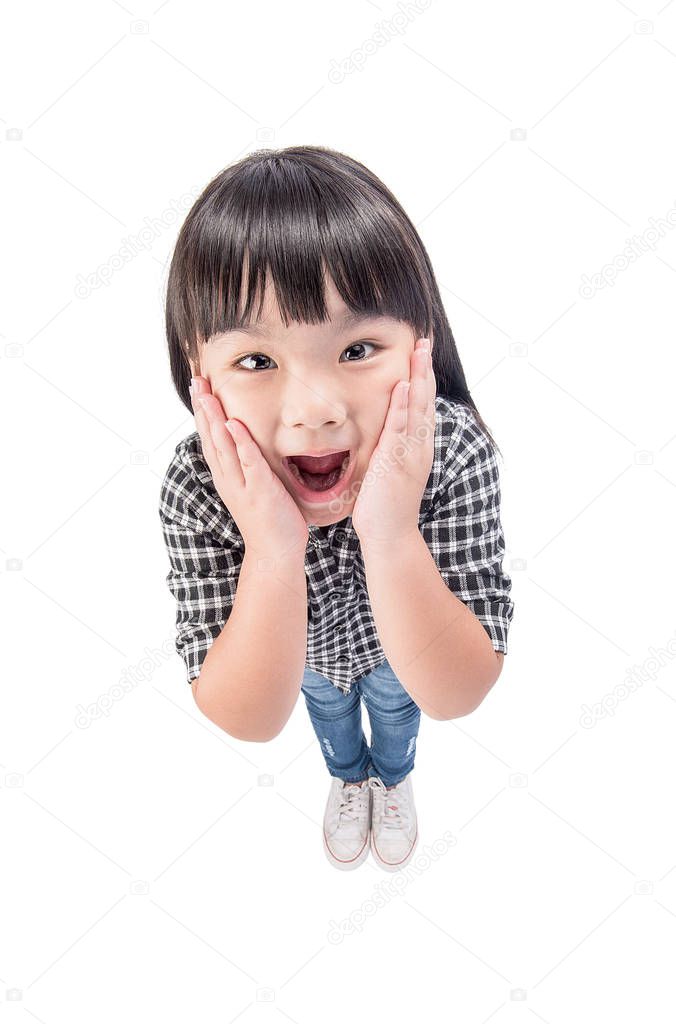 A surprised little girl in casual clothes with hands on cheeks isolated on white background