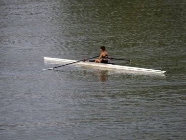 young woman in a black dress with a boat on the lake