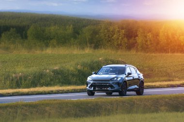 Modern SUV in motion through countryside area