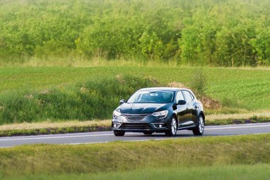 Modern compact automobile on urban asphalt road