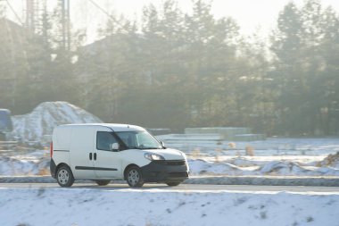 White delivery van on icy road