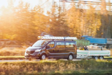 Work van with trailer transporting equipment