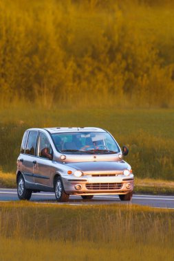 Vintage era vehicle from 90s traveling on highway