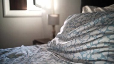 Sun flare and dust create dreamy bedroom mood