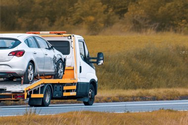 Damaged vehicle loaded onto roadside recovery truck
