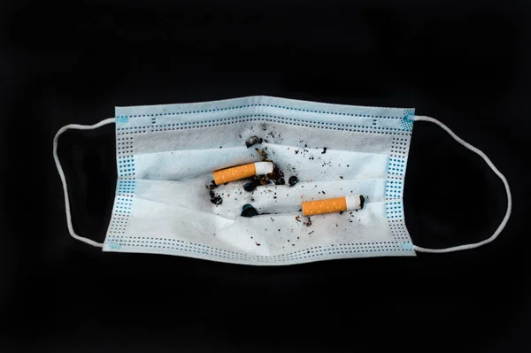 Face Mask Cigarette Stubs Used Ashtray Isolated Black — Stock Photo, Image