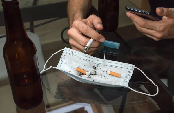 Man Using Mask Ashtray While Using Mobile Phone Home — Stock Photo, Image