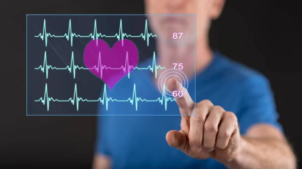 Man touching a heart beats graph concept on a touch screen with his finger