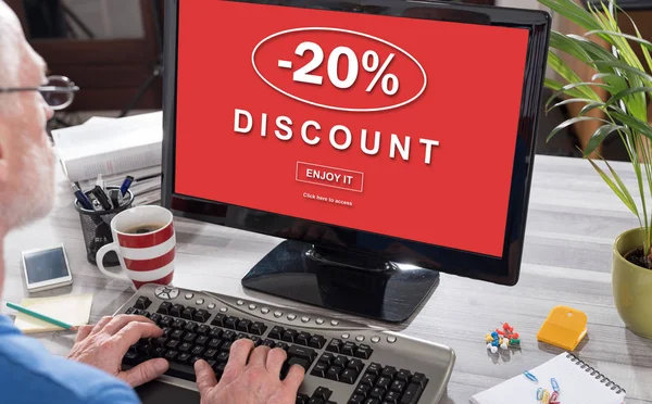 Man using a computer with discount concept on the screen