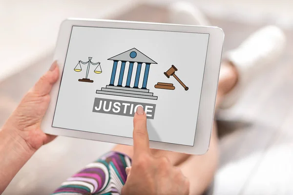 Woman using a tablet with justice concept