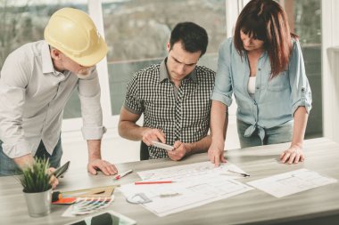 Planları ofiste çalışan mimarlar