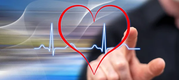Man touching a heart beats graph on a touch screen with his finger