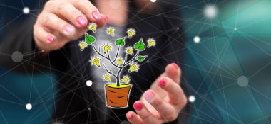 Arka planda bir kadının elleri arasındaki yeşil enerji kavramı