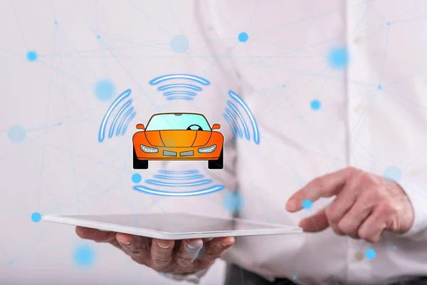 Smart car concept above a tablet held by a man in background