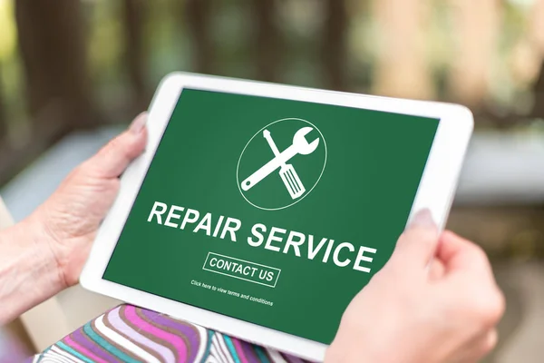 Female hands holding a tablet with repair service concept