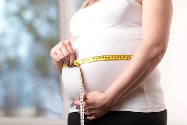 Mulher Grávida Medindo Sua Barriga Com Fita Métrica — Fotografia de Stock