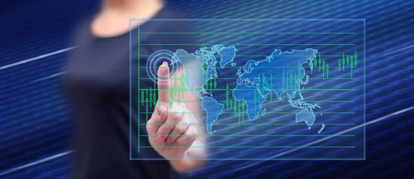 Woman touching a global business concept on a touch screen with her finger
