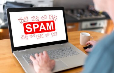 Spam konsepti üstünde belgili tanımlık perde ile bir dizüstü bilgisayar kullanan adam