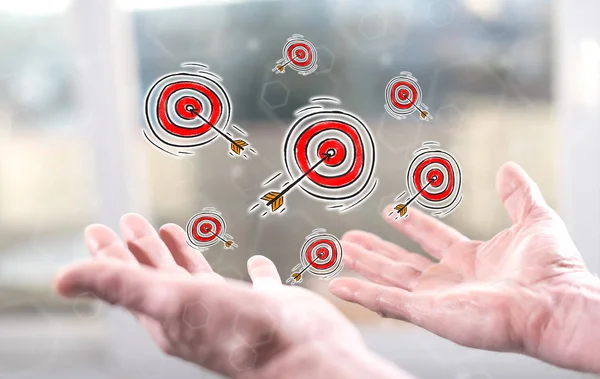 Business target concept above the hands of a man