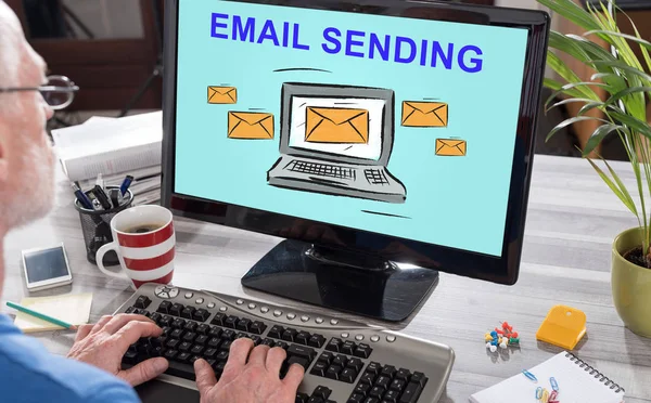 Man using a computer with email sending concept on the screen