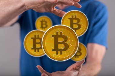 Arka planda bir adamın elleri arasında Bitcoin kavramı