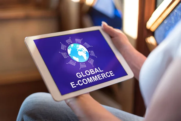 Woman holding a tablet showing global e-commerce concept