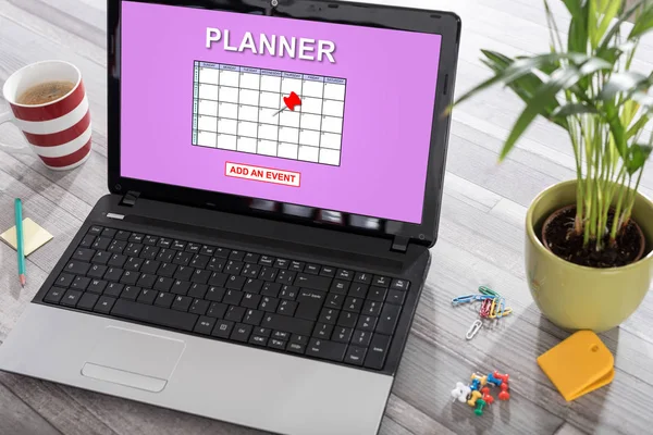 Laptop on a desk with event adding on planner concept on the screen
