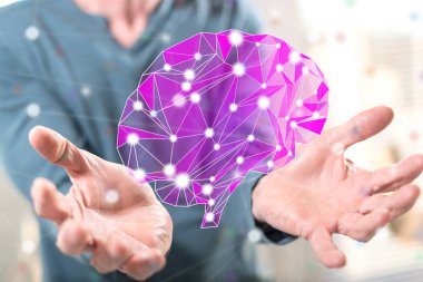Yapay zeka kavramı arka plandaki bir adamın elinden üstündür.