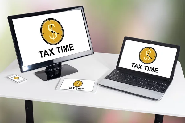 Tax time concept shown on different information technology devices