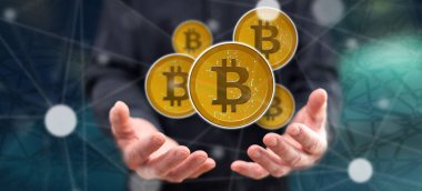 Bitcoin kavramı arka plandaki bir adamın ellerinden üstündür.