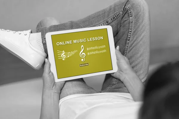 Woman looking at online music lesson concept on a tablet