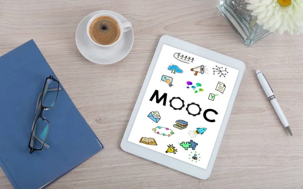 Top view of a desk with mooc concept on a digital tablet