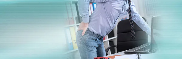 Businessman suffering from back pain in office. panoramic banner