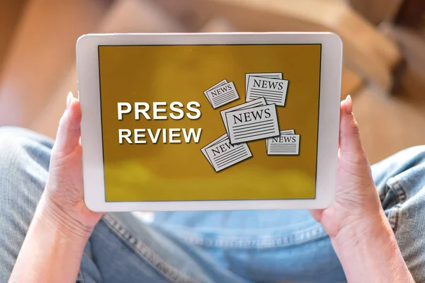 Tablet screen displaying a press review concept