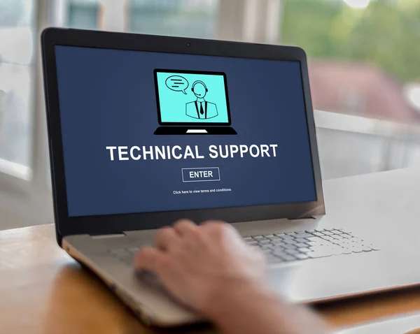 Man using a laptop with technical support concept on the screen