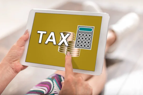 Woman using a tablet with tax concept